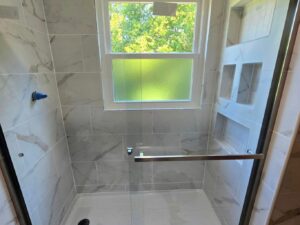 Finished modern bath remodel in Indiana by E & A Construction LLC featuring new flooring and updated interior design